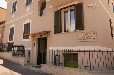 a building with a sign that reads new red mind be monitoring at Bivio - Casa Azzurra in Rome