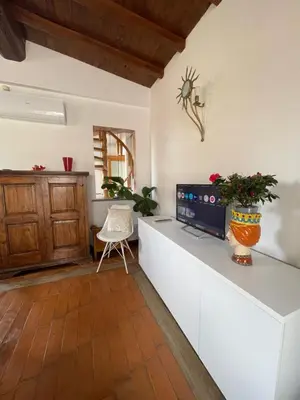 a kitchen with a counter with a tv on it at Attico Le Castelline in Rome