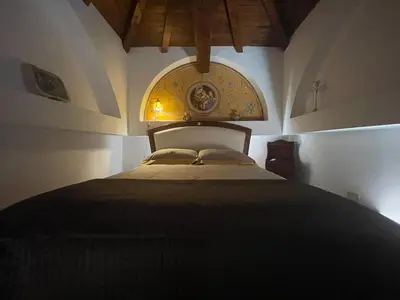a bedroom with a large bed in a room at Attico Le Castelline in Rome
