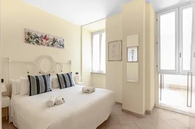 a bedroom with a white bed with two stuffed animals on it at Hostly-Volturno Suite Apartment-Center of Rome in Rome