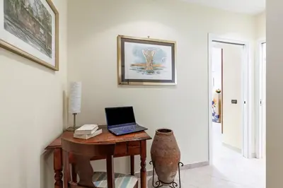 a room with a desk with a laptop on it at Hostly-Volturno Suite Apartment-Center of Rome in Rome