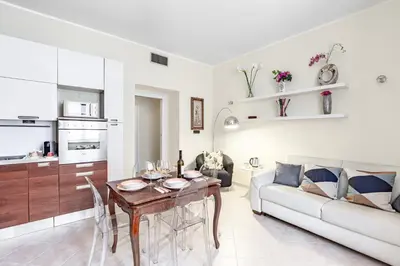 a living room with a couch and a table at Hostly-Volturno Suite Apartment-Center of Rome in Rome