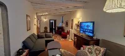 a living room with a couch and a flat screen tv at La Torre del Moro - RH Collection in Rome