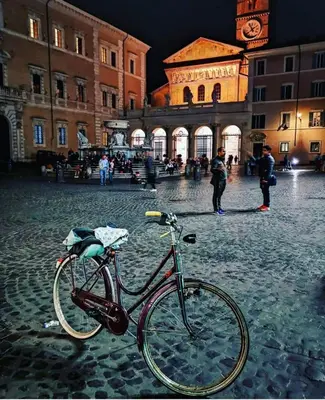 a bike parked on a street in front of a building at La Torre del Moro - RH Collection in Rome