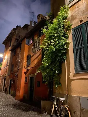 a bike parked next to a building with a clock at La Torre del Moro - RH Collection in Rome