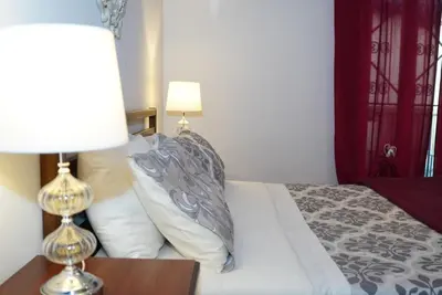 a bedroom with a bed with a lamp and pillows at La Torre del Moro - RH Collection in Rome