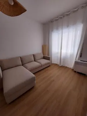 a living room with a couch in front of a window at Interno 4 al Vaticano in Rome