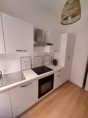 a kitchen with white cabinets and a white refrigerator at Interno 4 al Vaticano in Rome