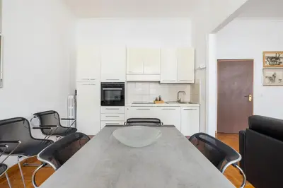 a kitchen with a table and chairs in a room at DOMUS GIULIA in Rome