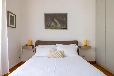 a bedroom with a white bed with white pillows at DOMUS GIULIA in Rome