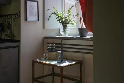a small table with a vase of flowers on a window at Sciampagne in Rome