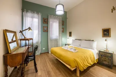 a bedroom with a bed and a desk and a mirror at Sciampagne in Rome