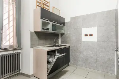 a kitchen with a sink and a dishwasher at HOME Suitte in San Giovanni near Basilica - Roma - in Rome