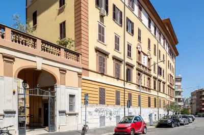 a red car parked in front of a building at HOME Suitte in San Giovanni near Basilica - Roma - in Rome