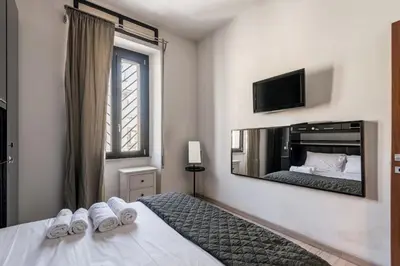 a bedroom with a bed and a large mirror at HOME Suitte in San Giovanni near Basilica - Roma - in Rome