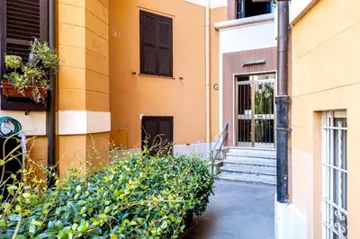 a building with stairs and plants next to a building at HOME Suitte in San Giovanni near Basilica - Roma - in Rome