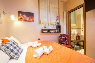a bedroom with a bed and a table in it at Starry Rome Guest House in Rome