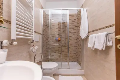 a bathroom with a shower with a toilet and a sink at Starry Rome Guest House in Rome