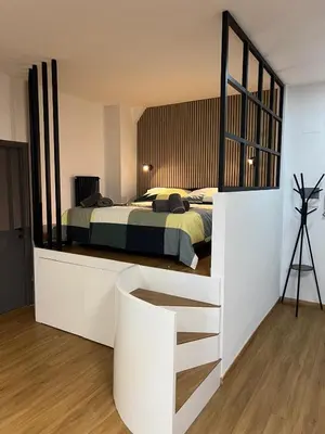 a bedroom with a bed and a large mirror at AThome104 in Rome