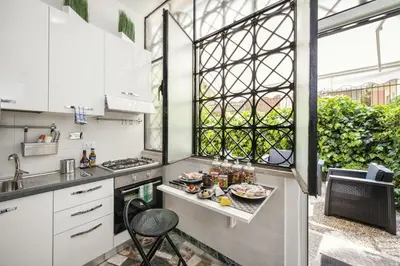 a kitchen with a table with food on it at Vatican House Apartment in Rome