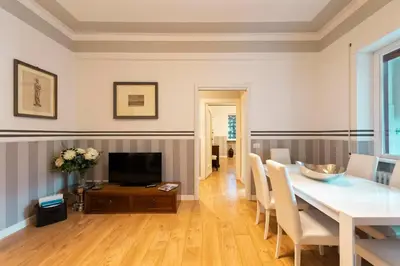 a bedroom with two beds and two windows at Vatican House Apartment in Rome