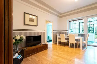 a living room with a table and a couch at Vatican House Apartment in Rome
