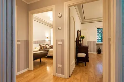 a bedroom with two beds and a couch at Vatican House Apartment in Rome