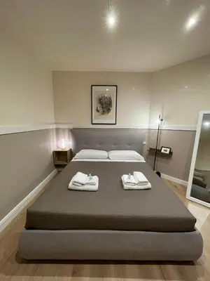 a bedroom with a large bed with towels on it at Elian Apartament in The Center of Rome #3 Colosseo in Rome