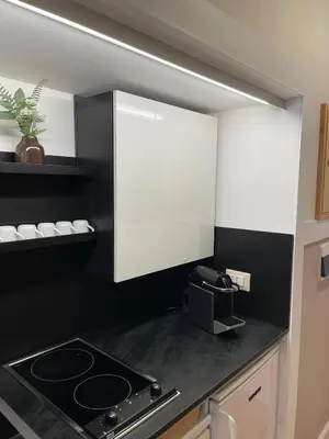 a kitchen with a stove and a white cabinet at Elian Apartament in The Center of Rome #3 Colosseo in Rome