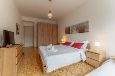 a bedroom with two beds and a flat screen tv at Casilina Green House - Metro Malatesta & Wi-Fi in Rome
