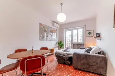 a living room with a table and a couch at Casilina Green House - Metro Malatesta & Wi-Fi in Rome