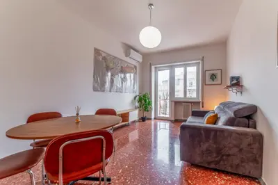 a living room with a table and a couch at Casilina Green House - Metro Malatesta & Wi-Fi in Rome