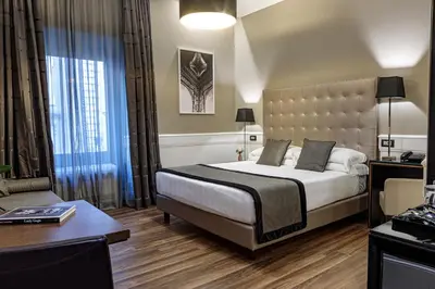 a hotel room with a bed and a table at The Independent Suites in Rome