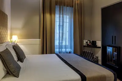 a hotel room with a bed and a window at The Independent Suites in Rome