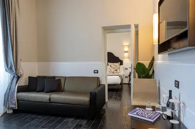 a living room with a couch and a bedroom at The Independent Suites in Rome