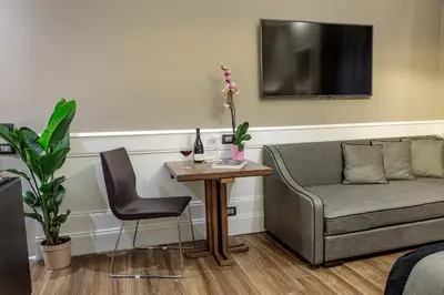 a living room with a couch and a table at The Independent Suites in Rome