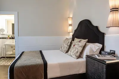 a bedroom with a bed with two pillows on it at The Independent Suites in Rome