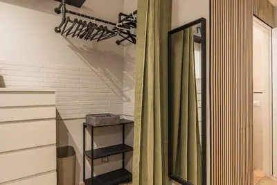 a bathroom with a shower curtain and a mirror at NEW! Monti 63 in Rome