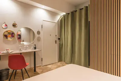 a bedroom with a bed and a desk and a mirror at NEW! Monti 63 in Rome