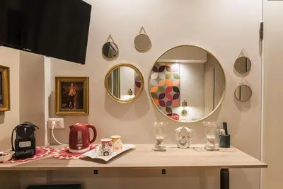 a mirror with a gold frame on a wall at NEW! Monti 63 in Rome