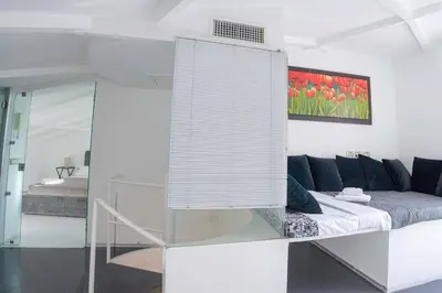 a white living room with a couch and a window at Vivi la Magia di Looney Tunes, piazza navona in Rome