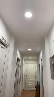a hallway with a white door and a ceiling at Colosseum home in Rome