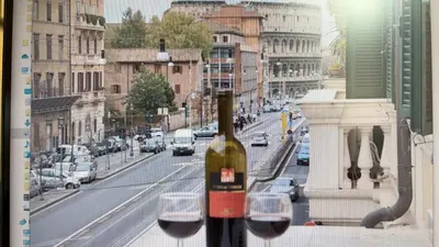 a bottle of wine sitting on top of a window at Colosseum home in Rome