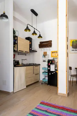 a kitchen with a counter and a table in a room at La Dolce Vita - Testaccio Authentic District 2 in Rome