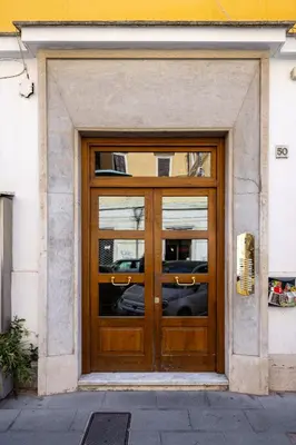 a large wooden door in a building at La Dolce Vita - Testaccio Authentic District 2 in Rome