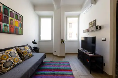 a living room with a couch and a flat screen tv at La Dolce Vita - Testaccio Authentic District 2 in Rome