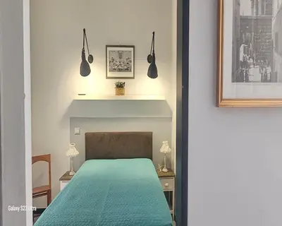 a bedroom with a bed with a green bedspread at Vatican Roma Caput Mundi in Rome