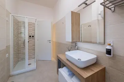 a bathroom with a white sink and a shower at Luxury and Sweet home-Metro Malatesta in Rome
