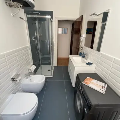 a bathroom with a toilet and a sink and a shower at The Place Milizie in Rome