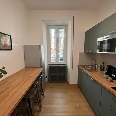 a kitchen with a counter top and a refrigerator at The Place Milizie in Rome